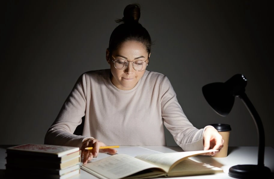 Professional ghostwriter writing a book at night